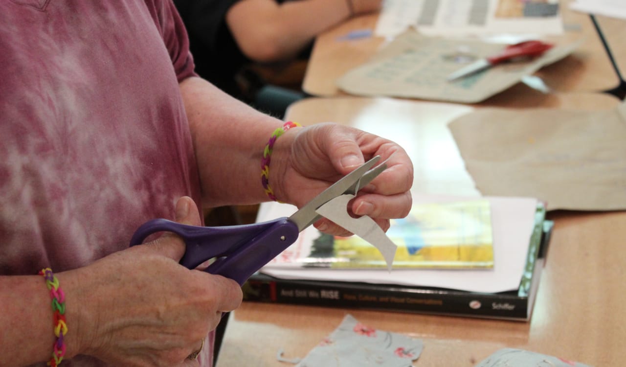 Debbie cutting out small pieces for her quilt square