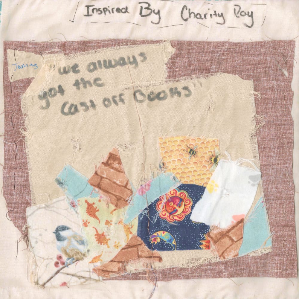 A quilt square depicting a pile of scraps with text in the upper left that says "We always got the cast off books". Text at the top says "Inspired by Charity Roy"