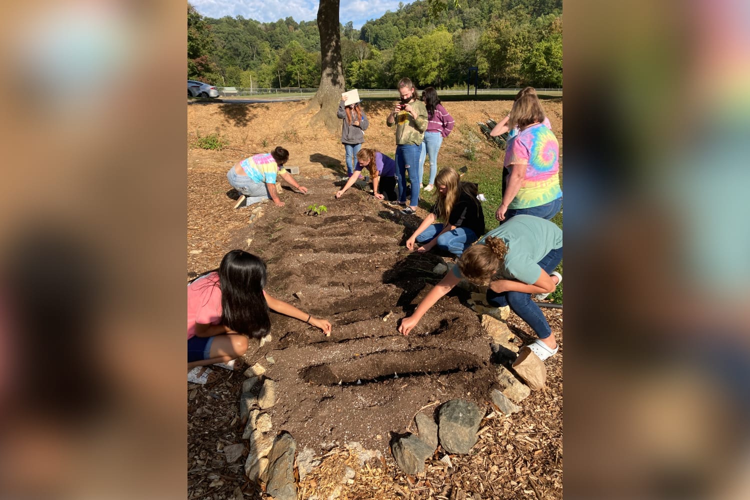 PAGE girls tending to a garden, planting seeds